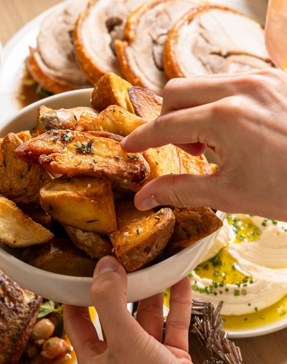 Roasted kipfler potatoes being shared at the Christmas table