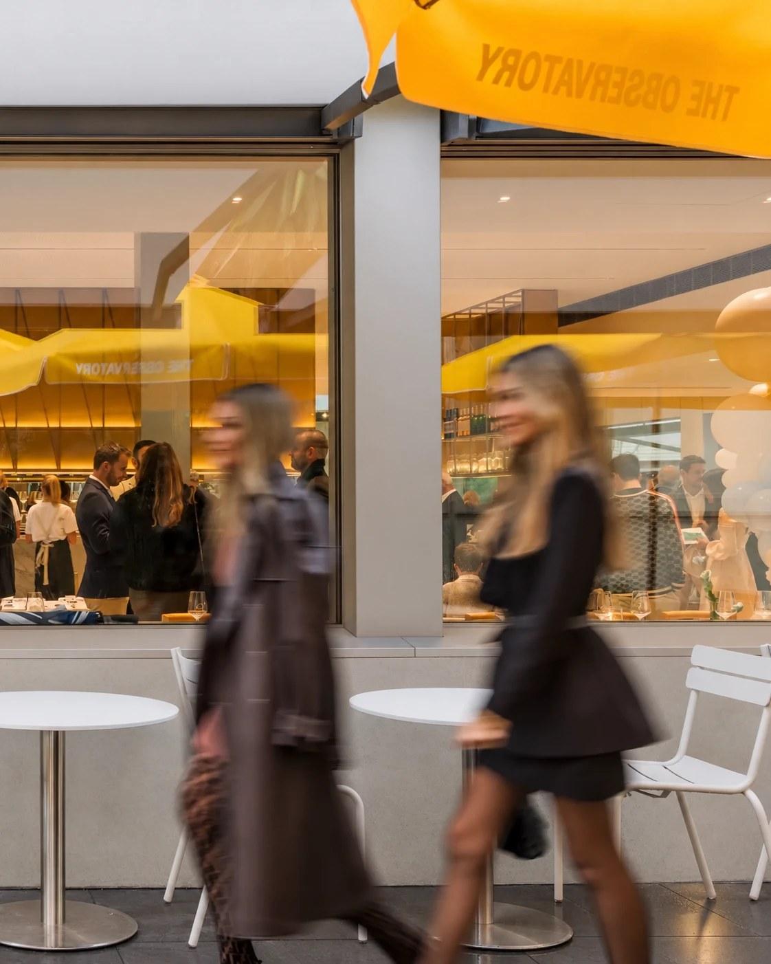 Guests walking past The Observatory as an event fills the dining room