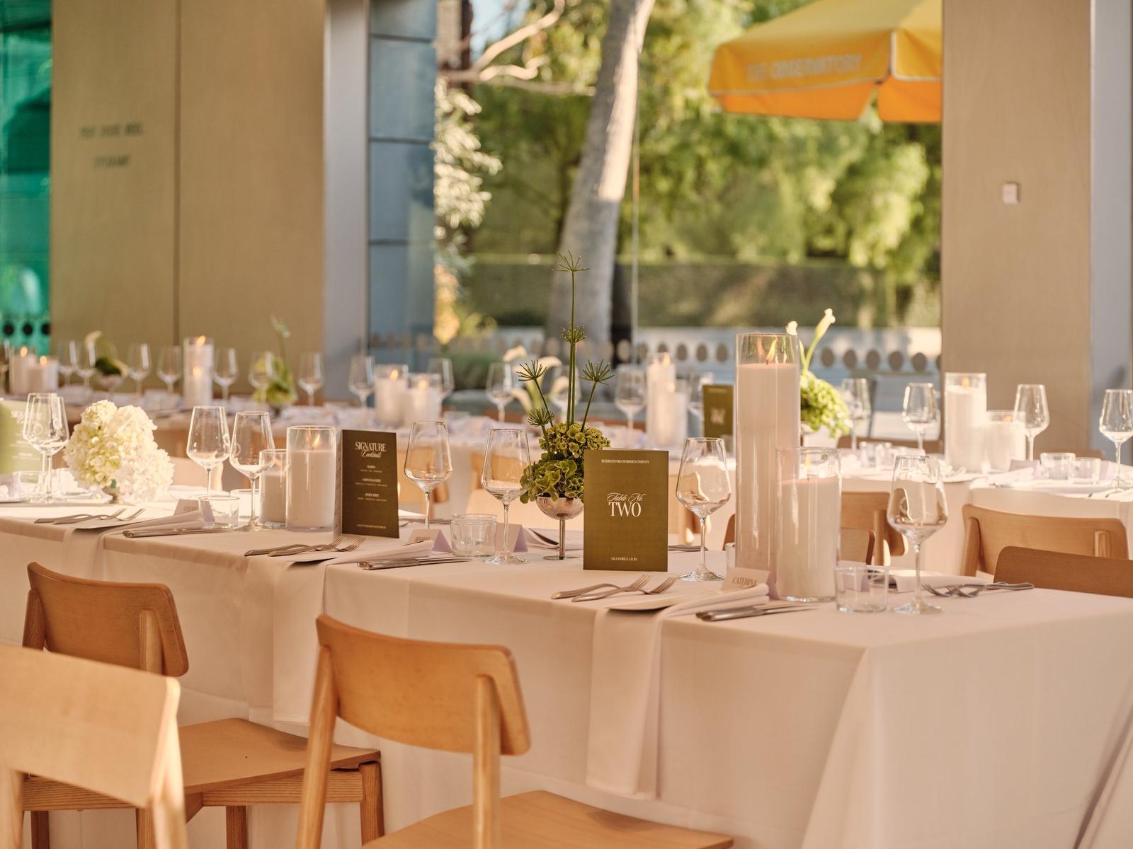 Event tables set with candles beside the courtyard at The Observatory