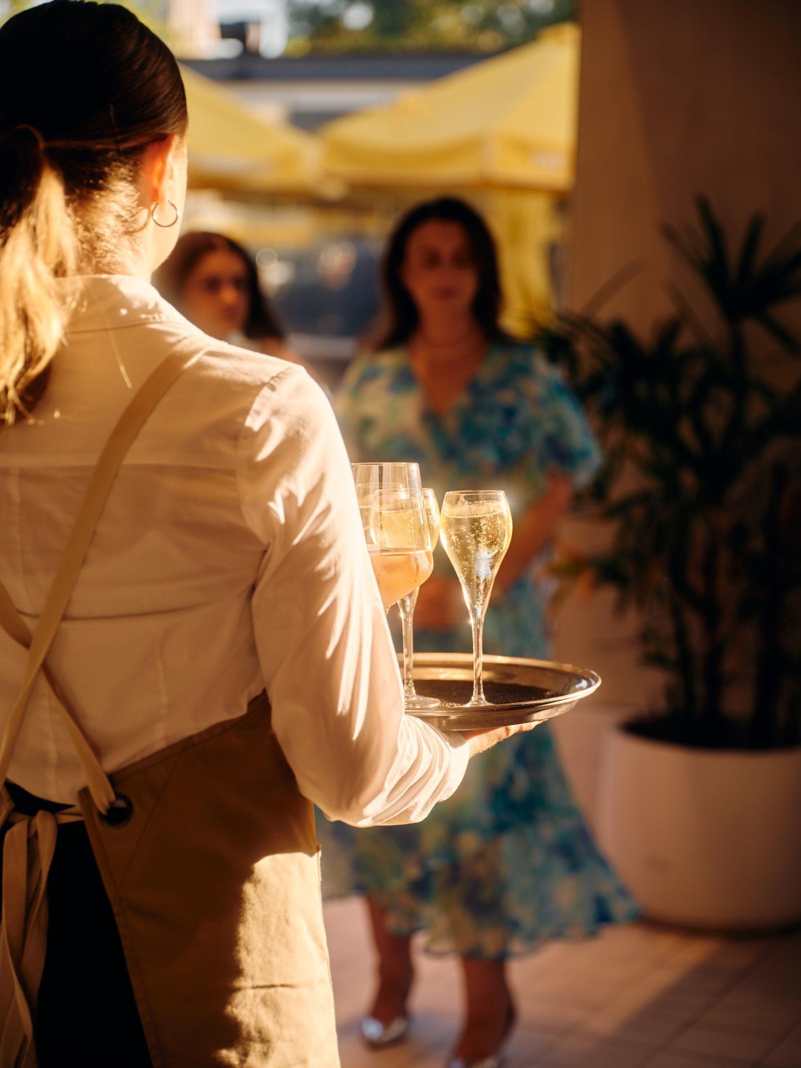 Staff serving Champagne to arriving guests at The Observatory
