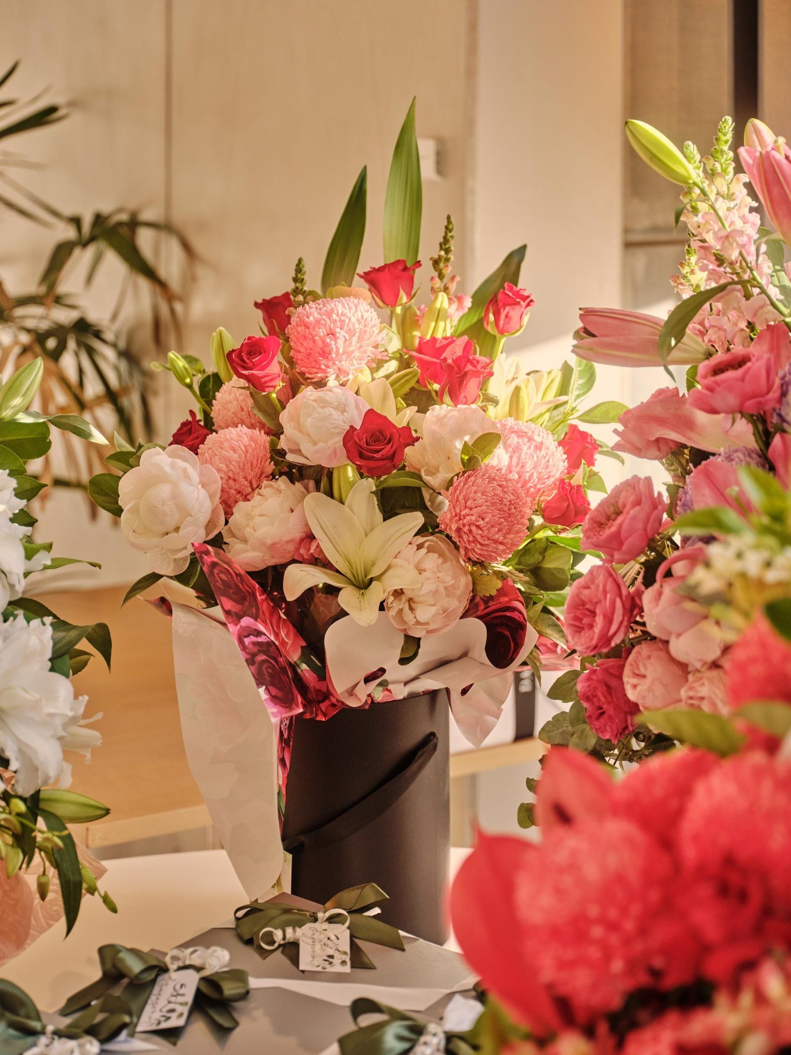 Red and pink floral arrangement at an event at The Observatory