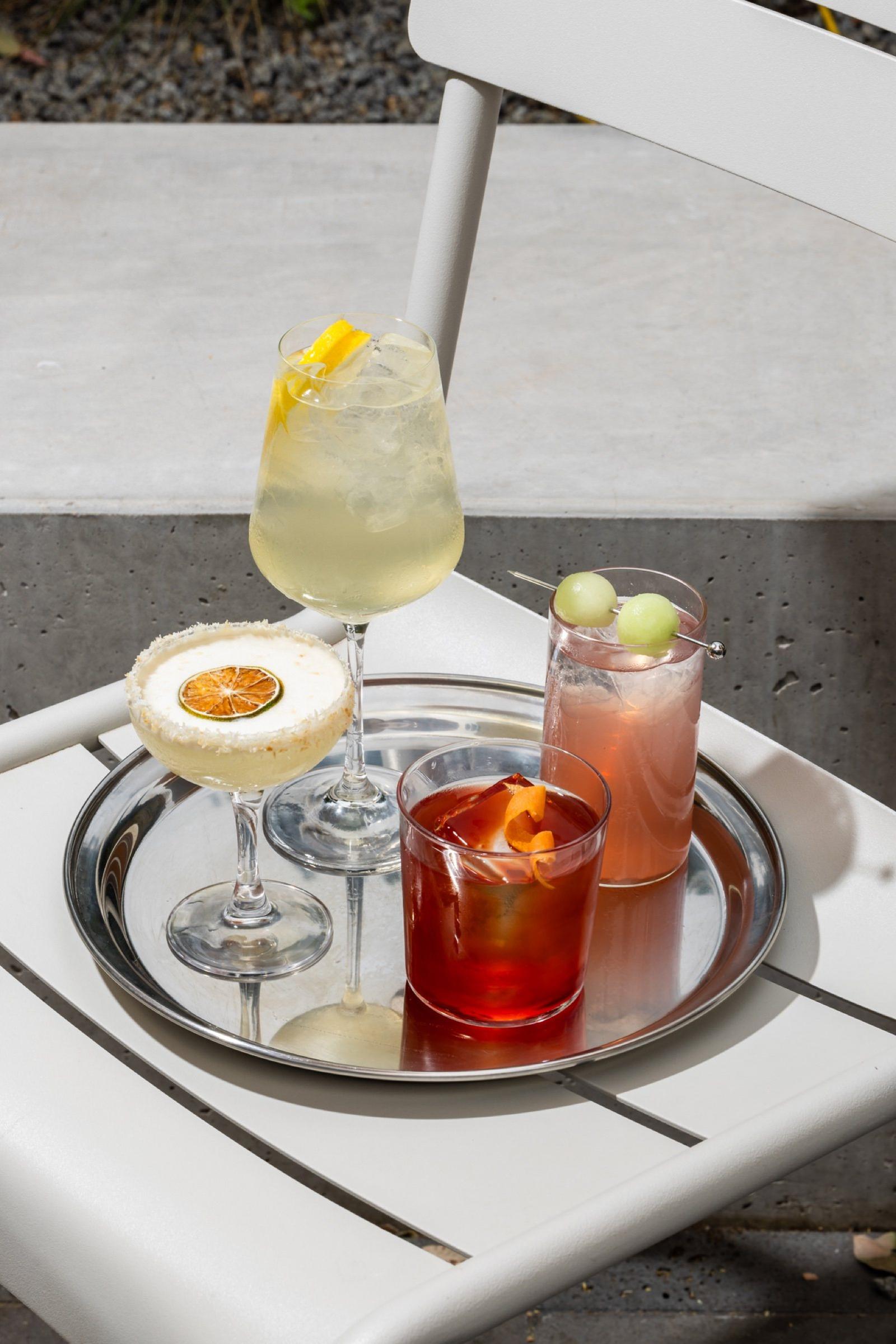 A tray of cocktails in The Observatory courtyard
